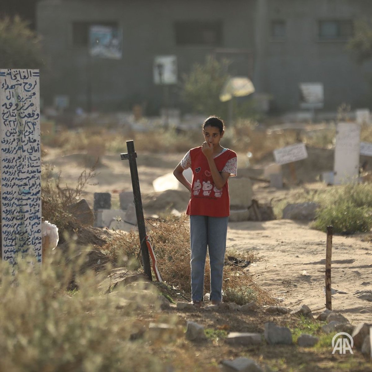 Palestinian child visits mass grave of 24 family members killed