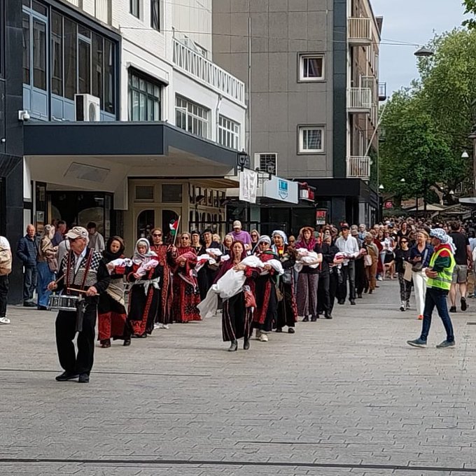 Dutch activists march with blood-stained shrouds protesting Gaza genocide