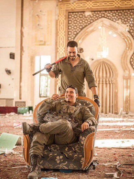 Israeli soldiers photograph looted Al-Awda Mosque in Rafah