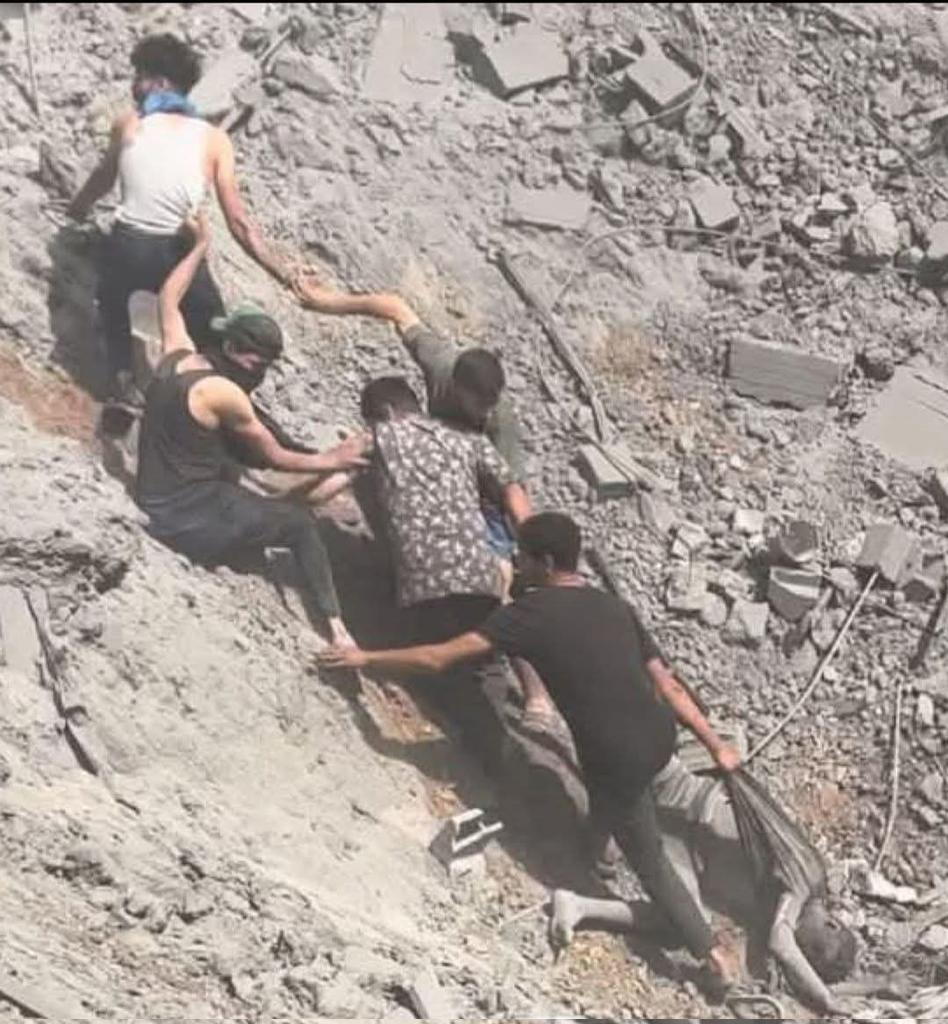Friends retrieve body from bombed house rubble amid occupation