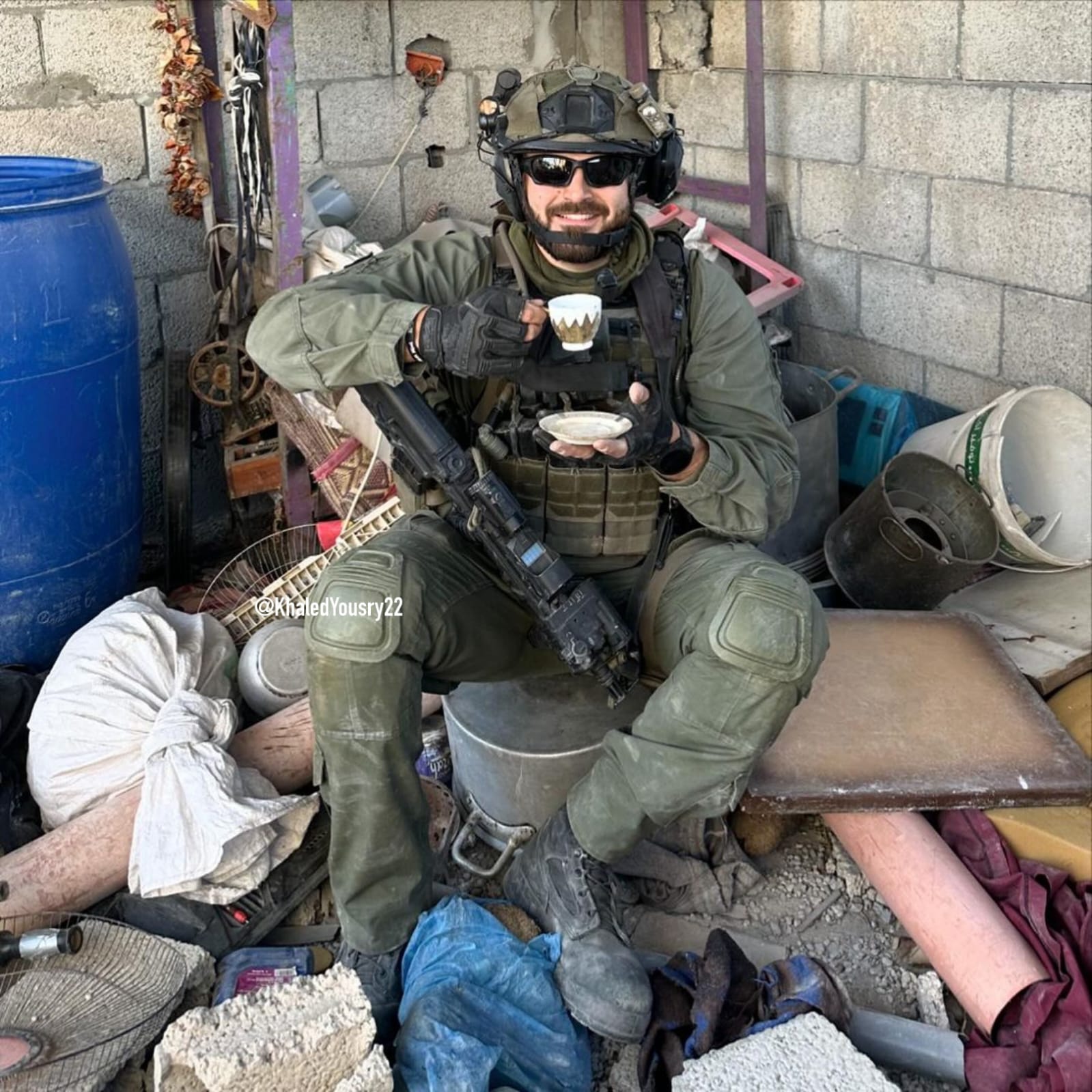 IOF soldier drinks coffee amid destroyed Gaza home rubble