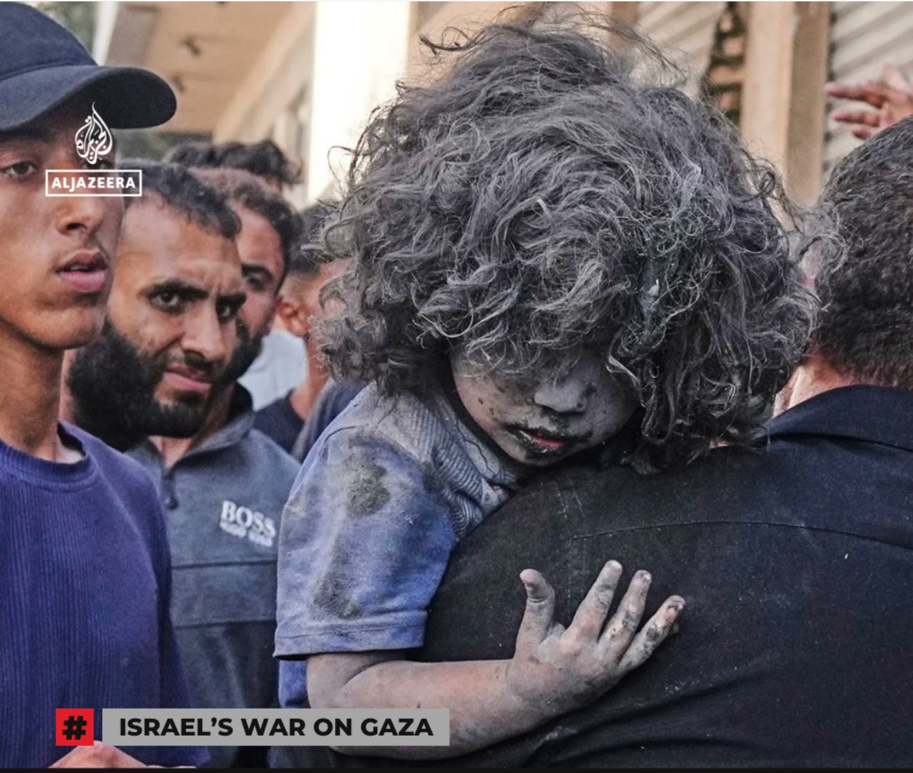 Palestinian man carries wounded child from Israeli attack Gaza