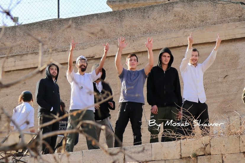 Settlers gesture at Palestinians during Hebron Mosque closure