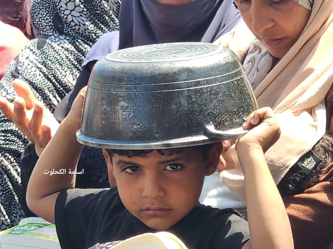 Displaced Gaza residents queue for charity meals amid famine crisis