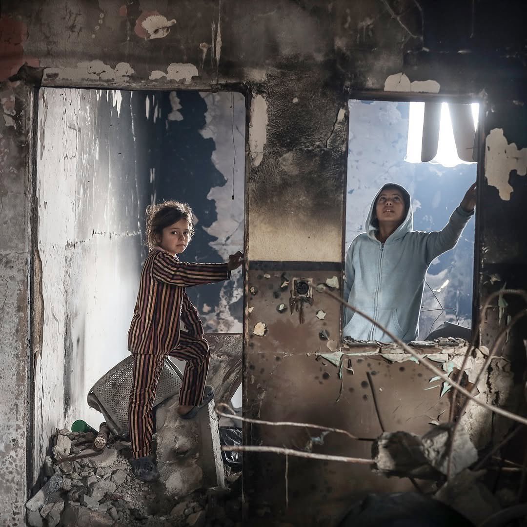 Palestinian girls inspect destroyed home in Shuja’iyya, Gaza