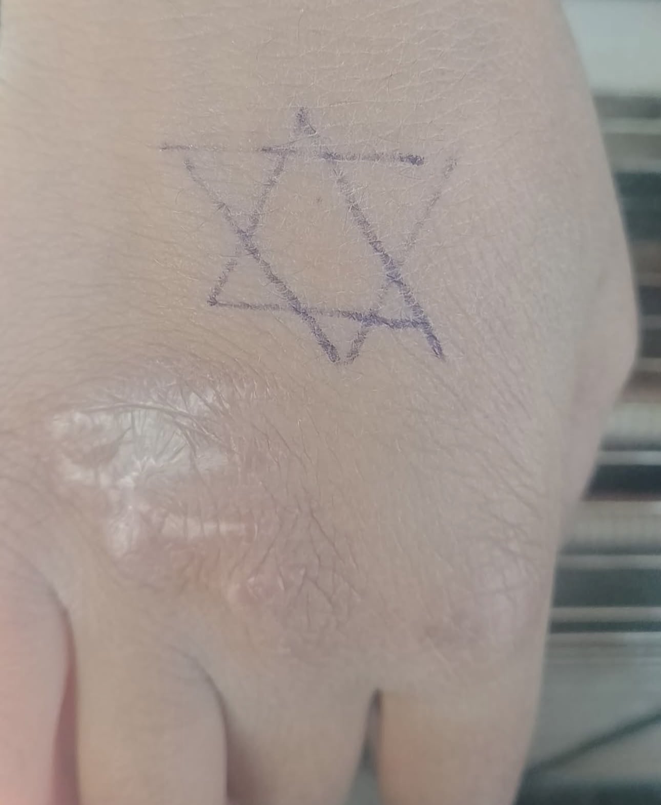 Israeli soldier draws Star of David on Palestinian child’s hand