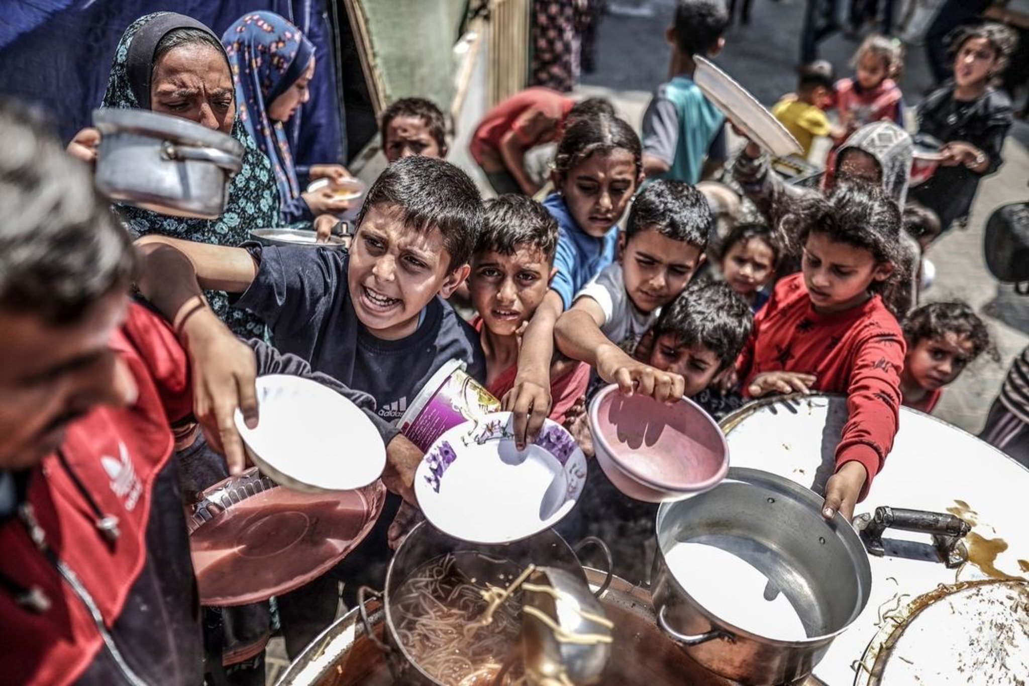 Palestinian Children Receive Food Aid Amid Gaza Crisis