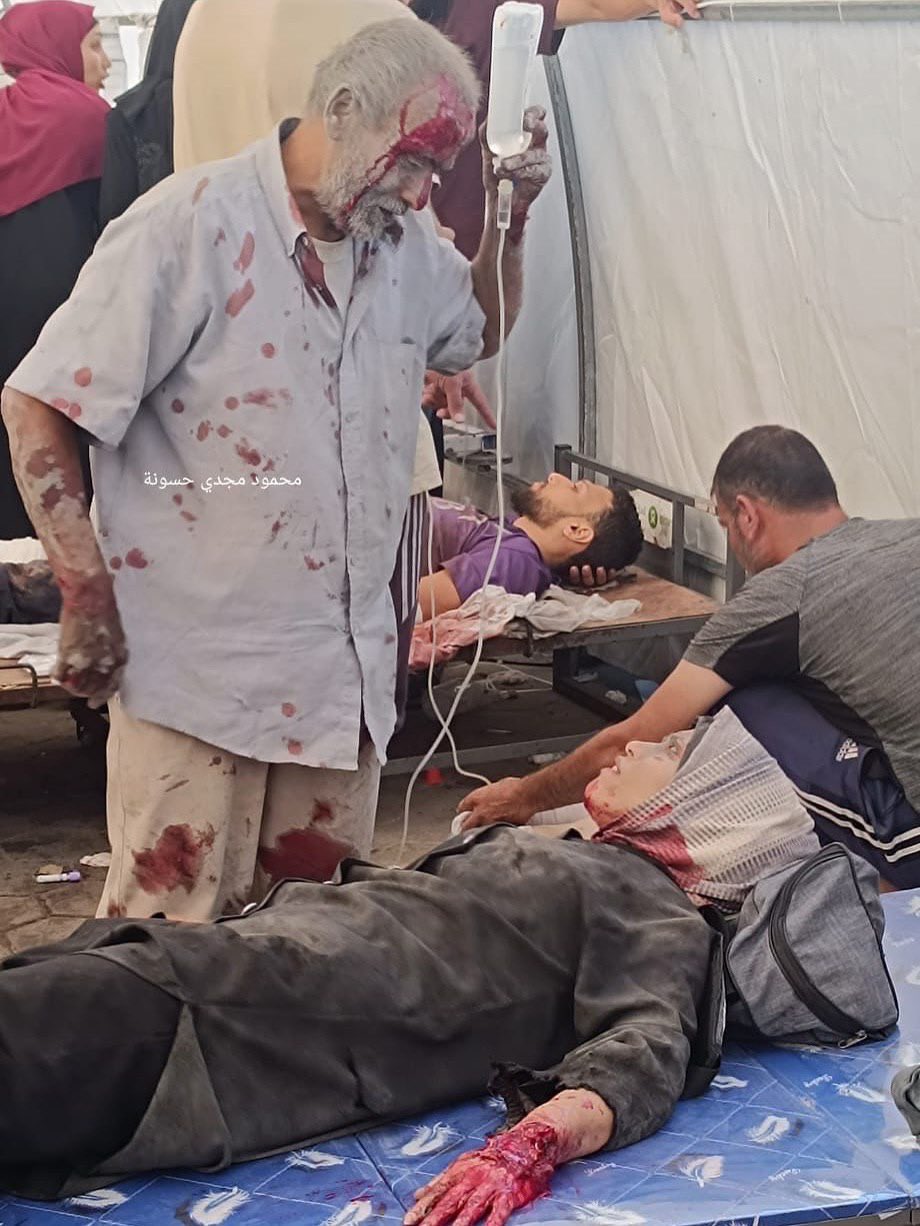 Palestinian elderly man holds medicine for injured daughter Gaza