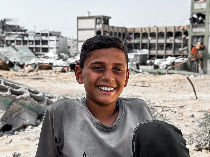 Abdullah Al-Za’anin, 12, lies beside school bag, longing for play