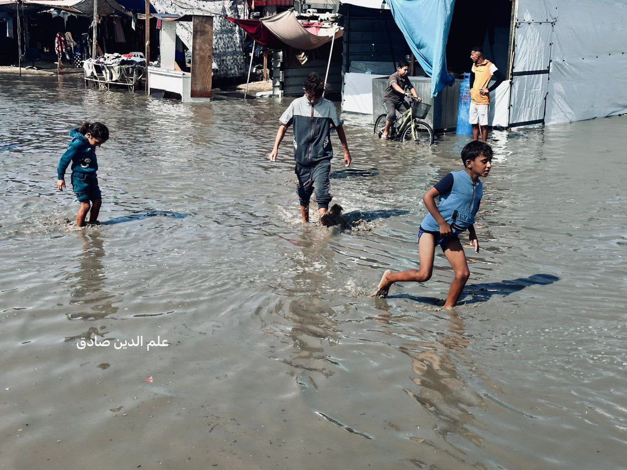 Heavy rain floods tents sheltering displaced Palestinian families in Gaza