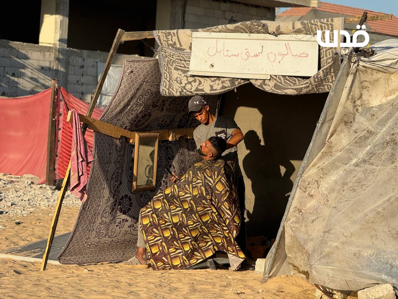 Displaced Barber Creates Makeshift Shop from Fabric Scraps