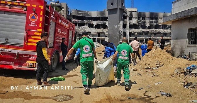 Civil defense searches for bodies of Palestinians killed at Shefa hospital