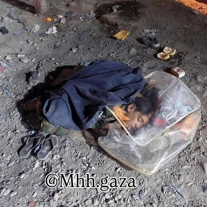 Child in Gaza sleeps on ground with plastic sheet