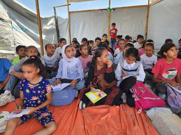 Gaza children study without desks on cold floors