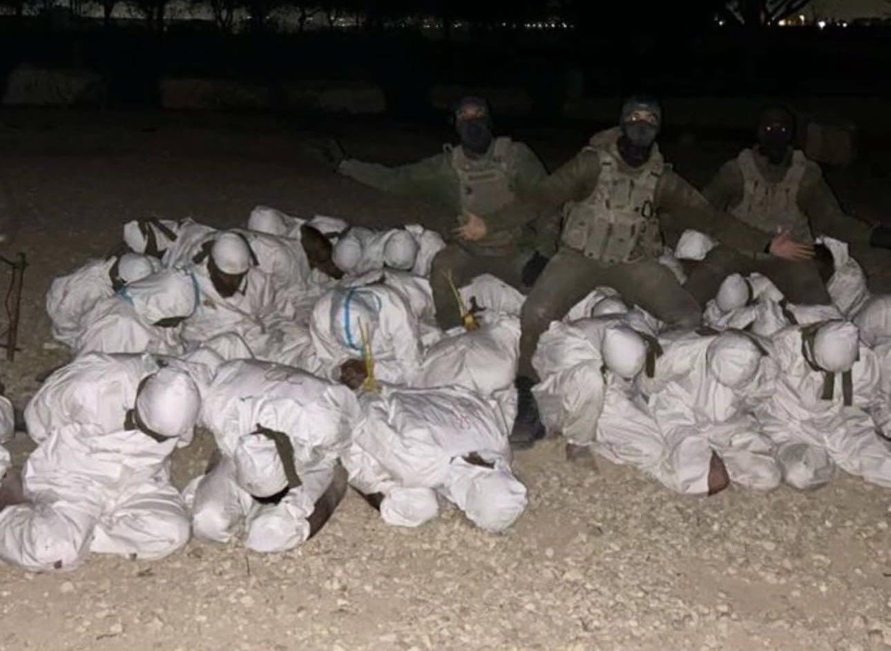Israeli soldiers celebrate with abducted Palestinians from Jabalia