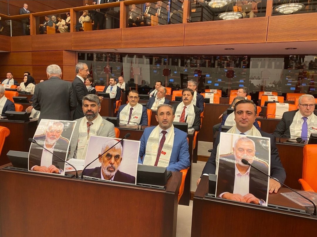 Turkish parliament members hold photos during Abbas speech