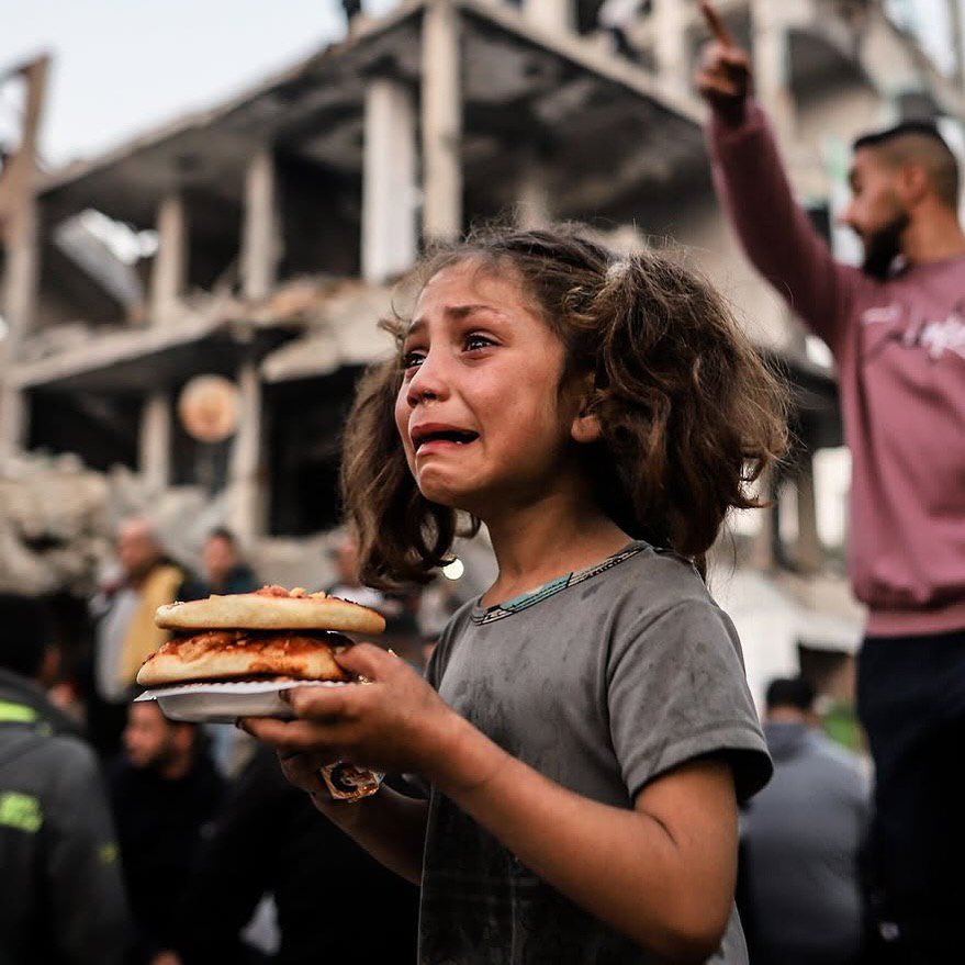 Girl carries food amid Gaza devastation during Ramadan