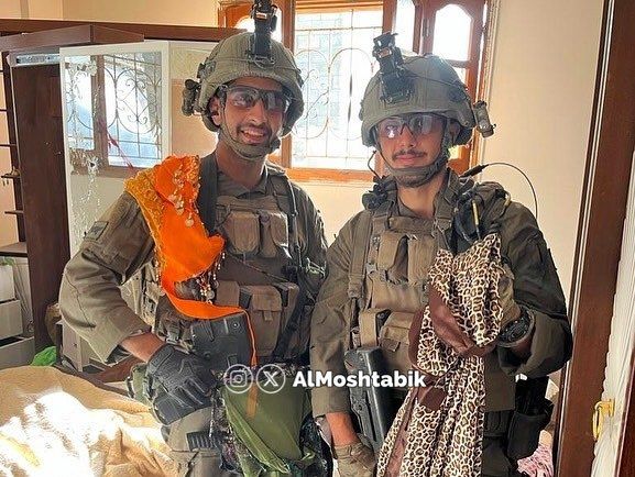 Israeli soldiers looting Palestinian homes and wearing displaced women’s clothes