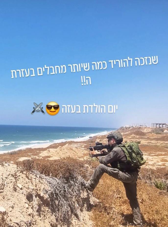 Israeli soldier poses armed on Gaza beach, vows to flatten Gaza