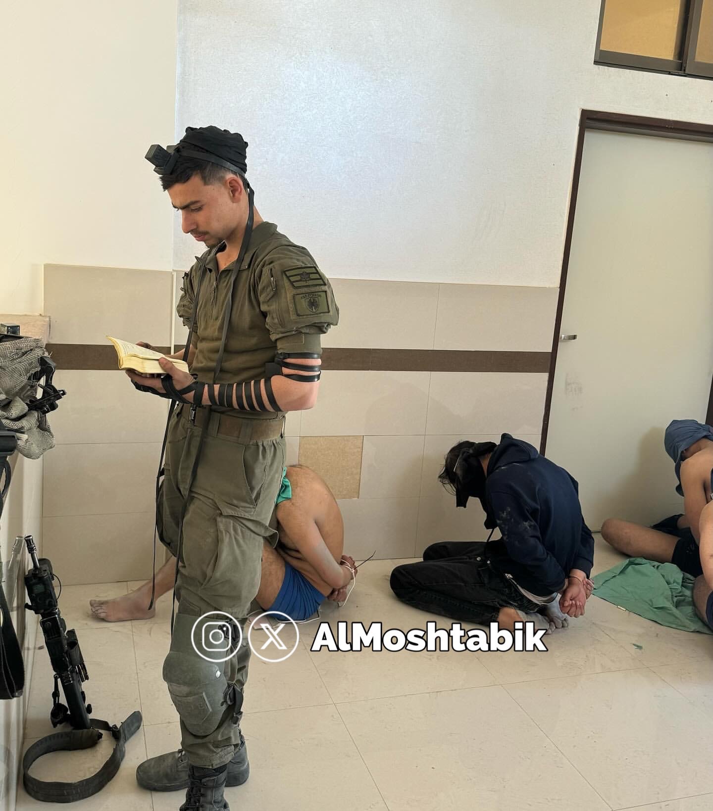 IOF soldier performs rituals while Palestinians held blindfolded captive
