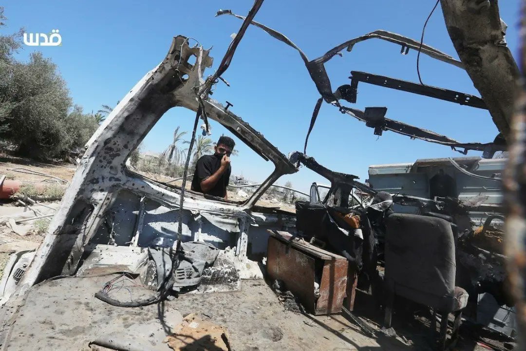 Palestinians inspect vehicle bombed by Israeli warplanes in Gaza