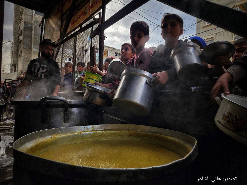 Palestinians in Rafah Wait for Food During Siege