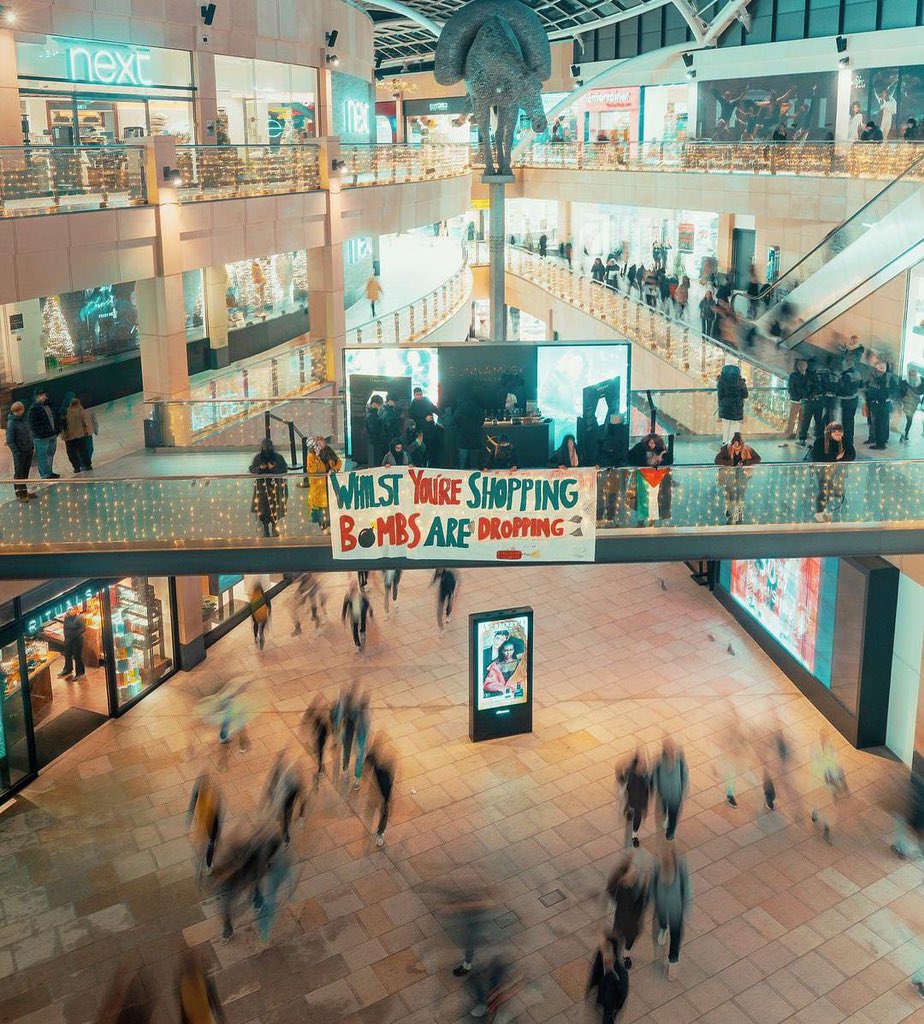 Leeds protest banner criticizes shopping amid warfare