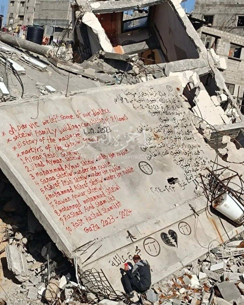 Palestinian man writes names of family members killed in Gaza