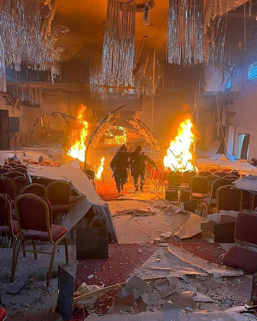Israeli soldiers photograph themselves in burned Gaza wedding hall