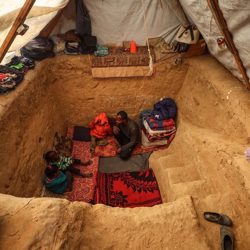 Displaced Palestinian digs underground shelter in Gaza tent camp