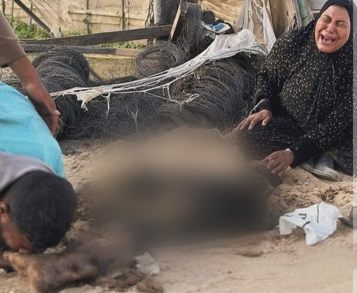 Woman cries as man kisses father’s remains after Israeli bombardment in Rafah