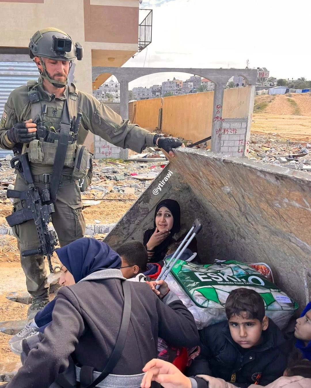 Israeli soldier detaining women children on D9 bulldozer