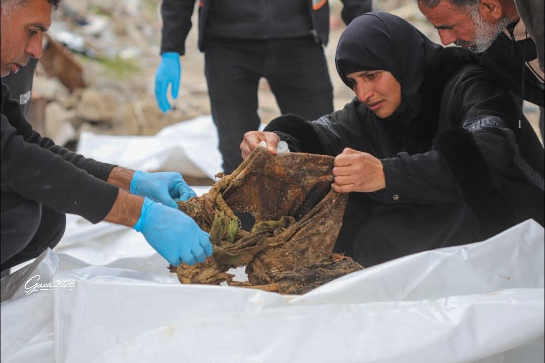 Palestinian woman searches rubble for missing family members Gaza