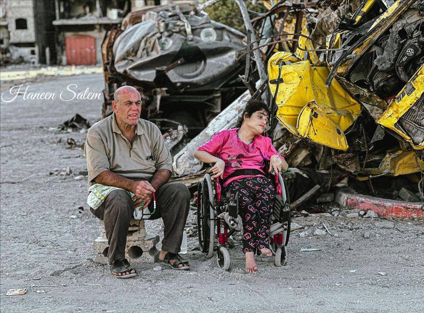Palestinian Woman with Spastic Quadriplegia Sits in Rubble with Father