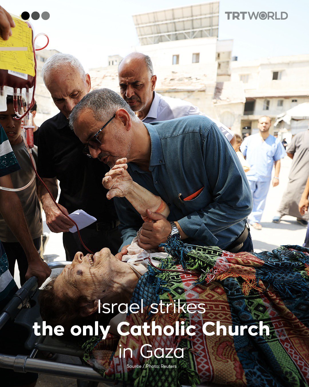 Doctor comforts elderly Christian woman injured in Gaza church strike