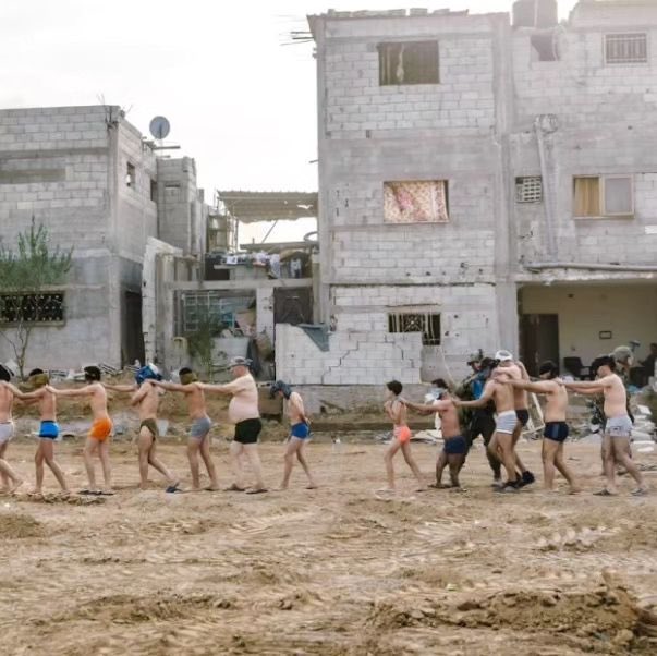 Detained Palestinians stripped to underwear, blindfolded in line
