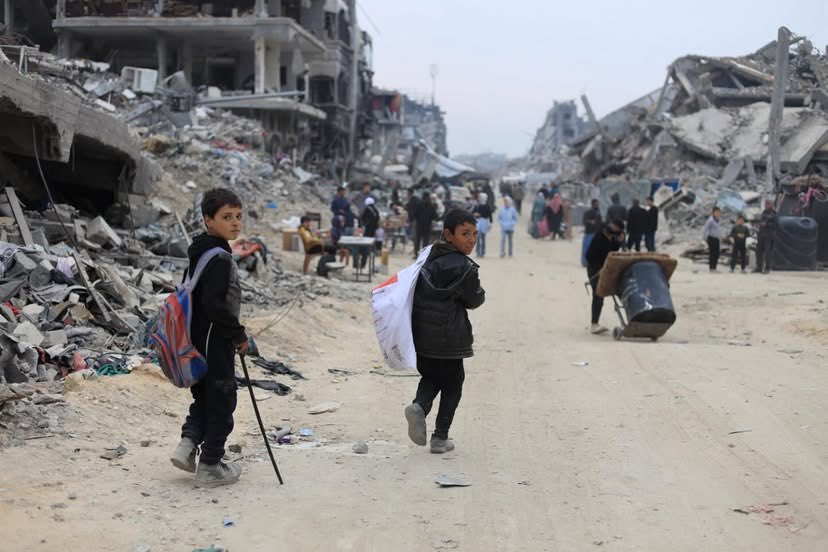 Children in Jabalia Camp carrying survival necessities instead of books