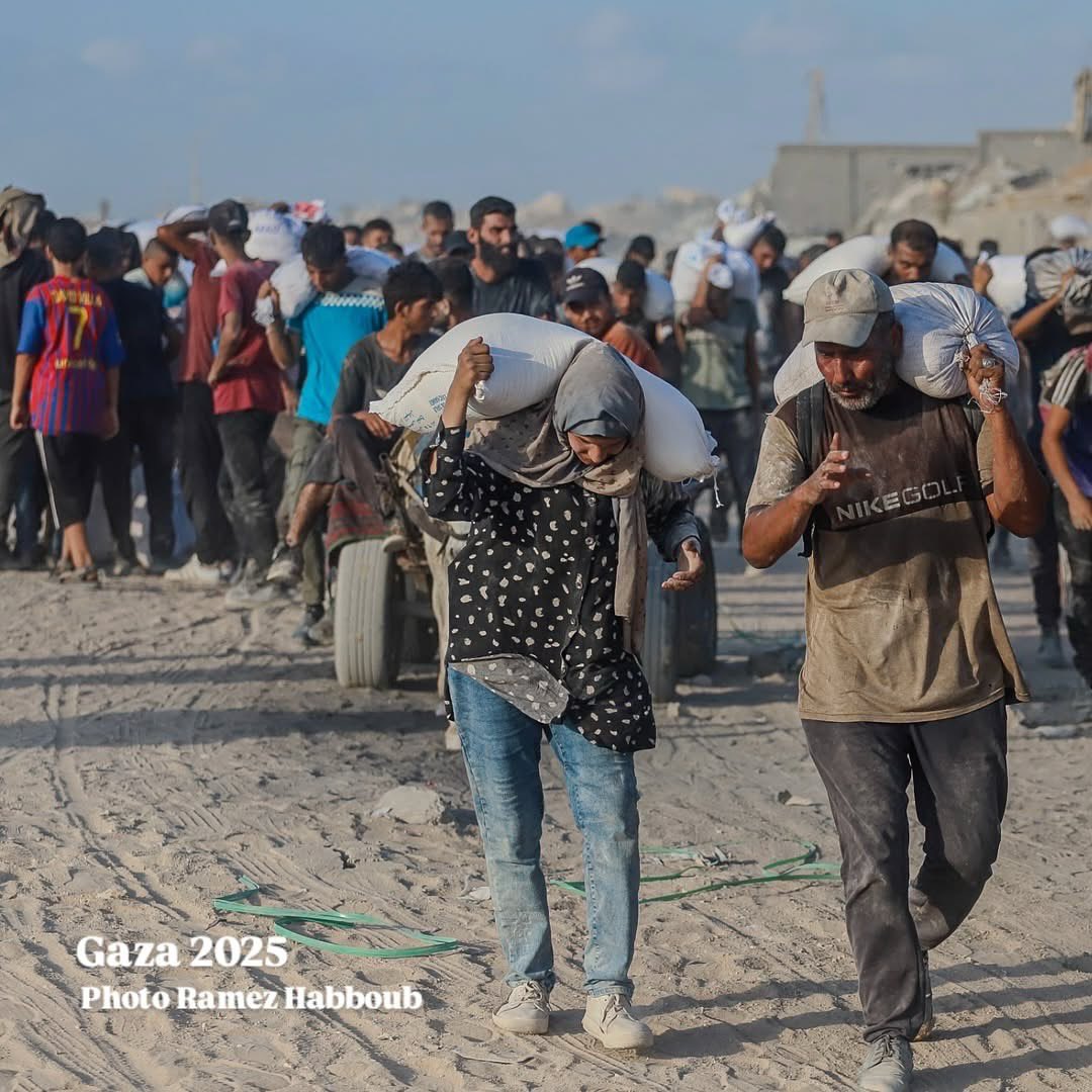Women carry flour through Gaza’s humanitarian crisis at Zikim