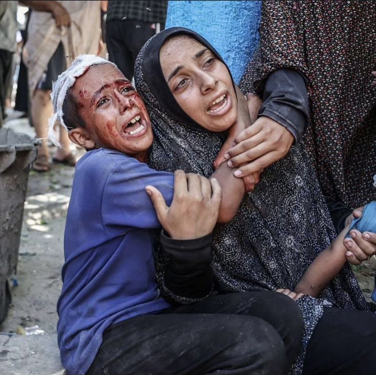 Injured child embraces mother after Israeli airstrike on UNRWA school