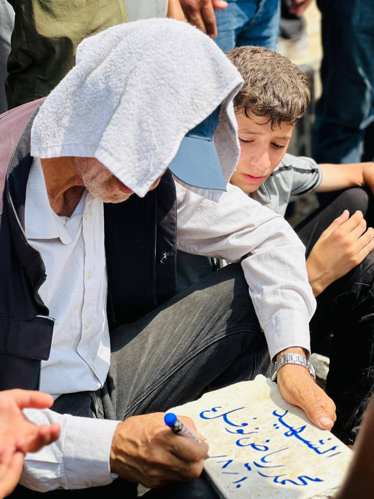 Riyad Writes Son’s Name at Grave in Jabalia