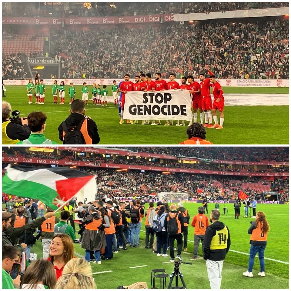Palestinian supporters display flags at football match against Spain