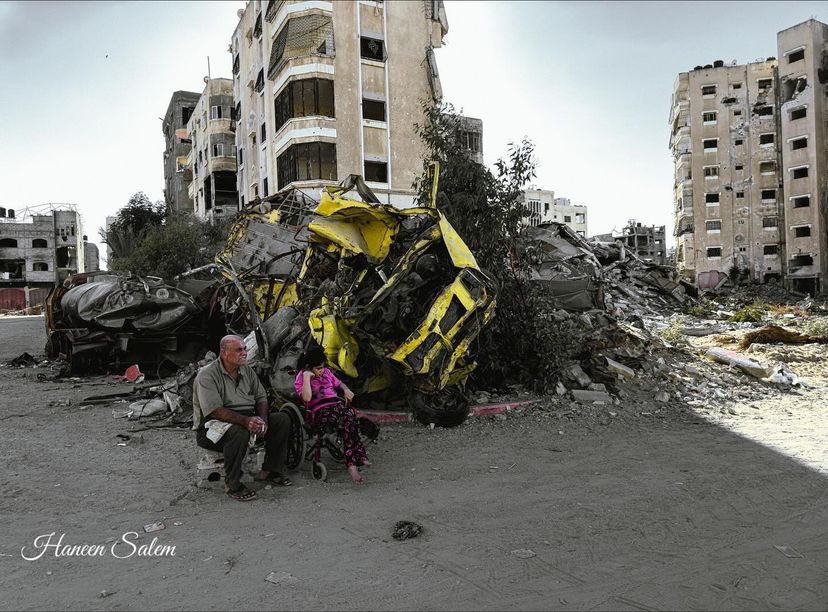 Disabled woman comforted by father amid rubble of destroyed home