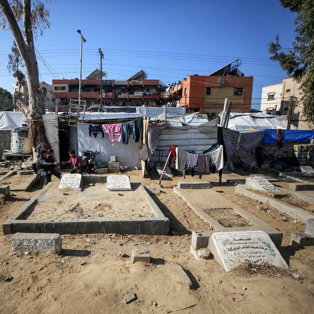 Displaced people live in tents inside cemetery in Gaza Strip