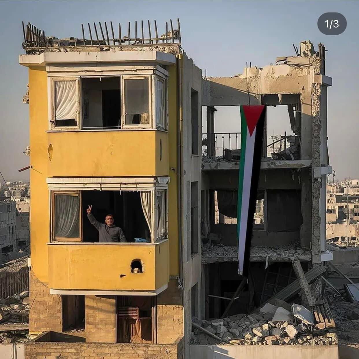 Palestinian Man Shows Victory Sign in Destroyed Gaza Home