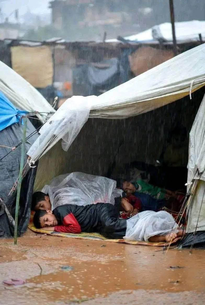 Children Shelter from Heavy Rain Flooding Gaza Strip