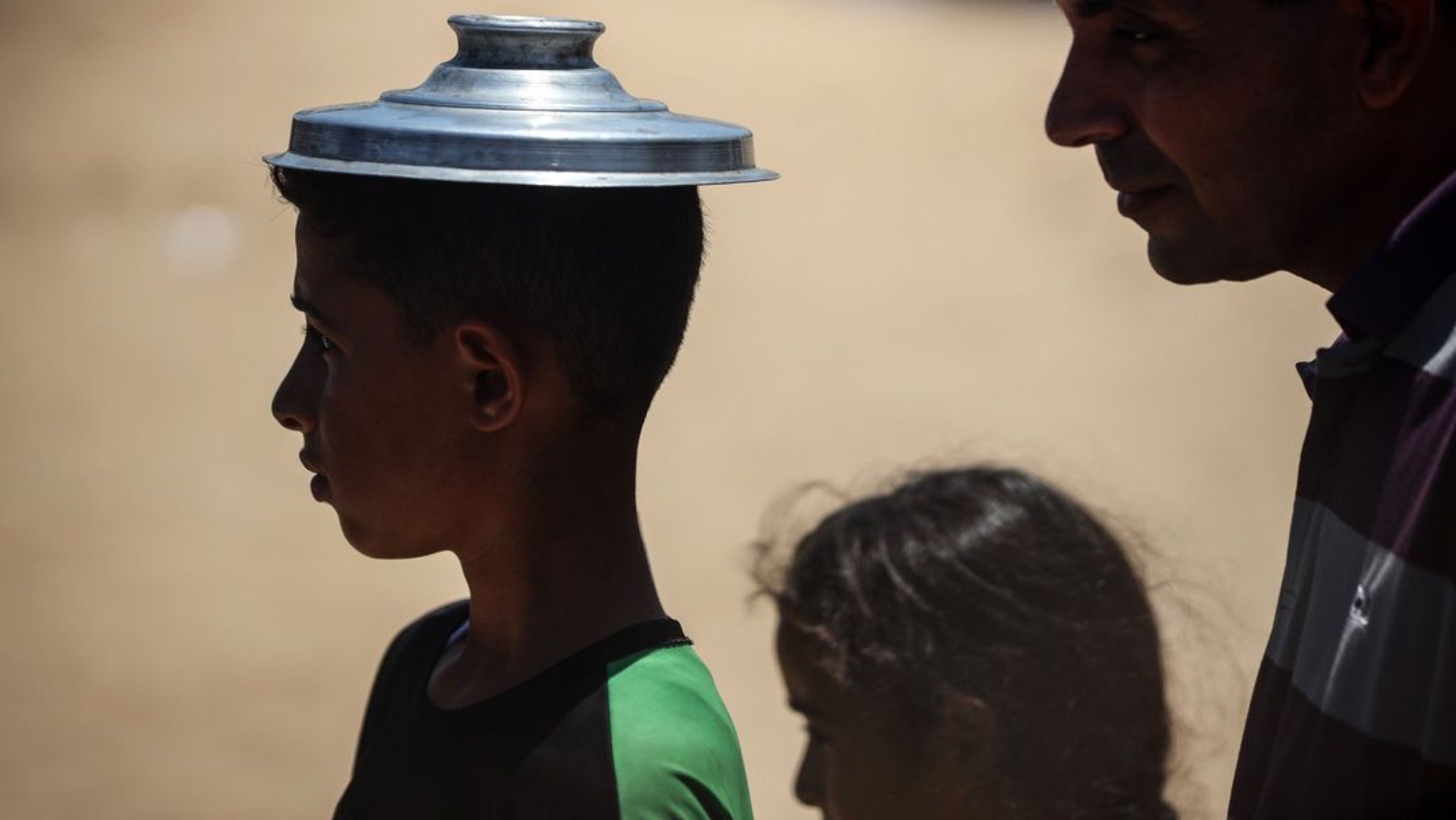 Palestinian Children Receive Food Aid at Deir el-Balah Displacement Camp