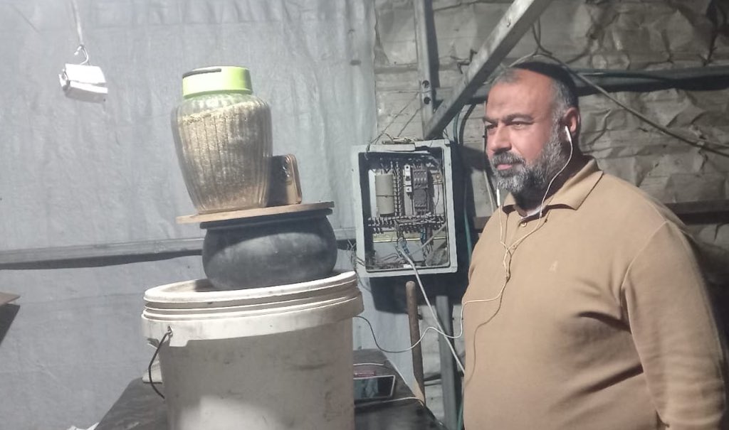 Palestinian man repairs phone with kitchen tools amid family loss