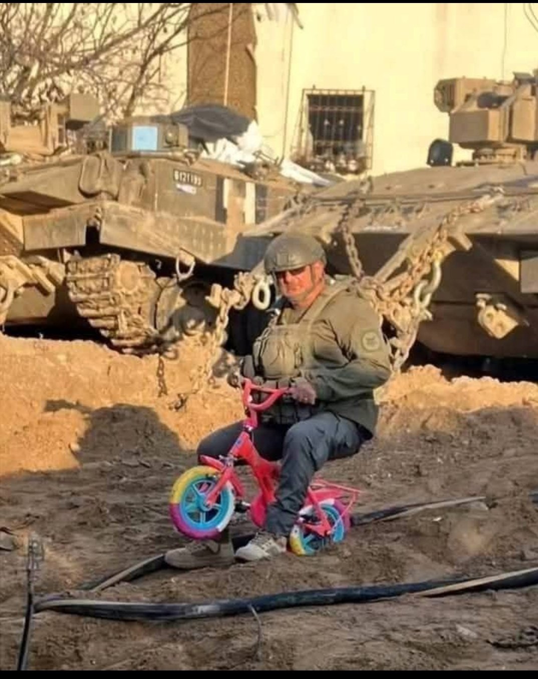 Armed soldier on child’s bicycle symbolizes Gaza’s lost innocence