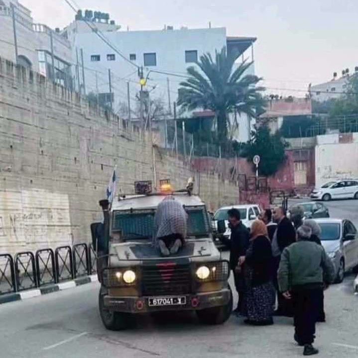 Palestinian mother climbs on Israeli military vehicle after children arrested