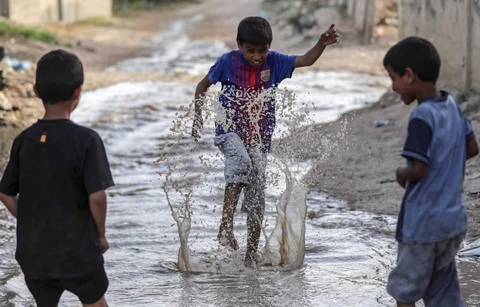 Children Playing in Polluted Rainwater Amid Infrastructure Destruction